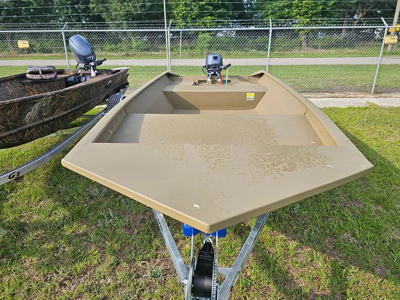 Slide: The Image of 2025 G3 Gator Tough 1548 VBW boat on trailer, grassy area, fence background. - 3