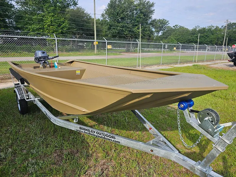 Slide: The Image of 2025 G3 Gator Tough 1548 VBW boat on trailer, parked on grass near a fence. - 4