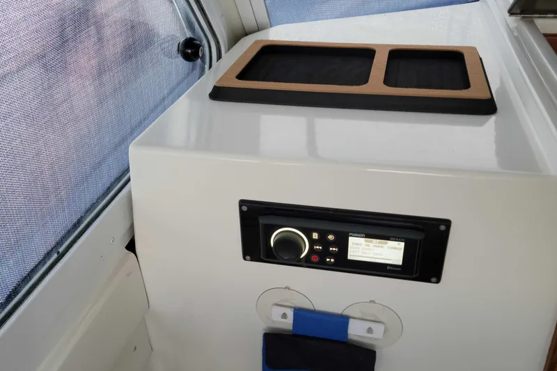 Slide: The Image of Interior view of a 2000 Hunt Yachts 29, featuring a control panel and storage area. - 25