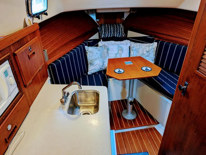 Slide: The Image of Cozy cabin interior of 2000 Hunt Yachts 29 with kitchenette and seating area. - 27