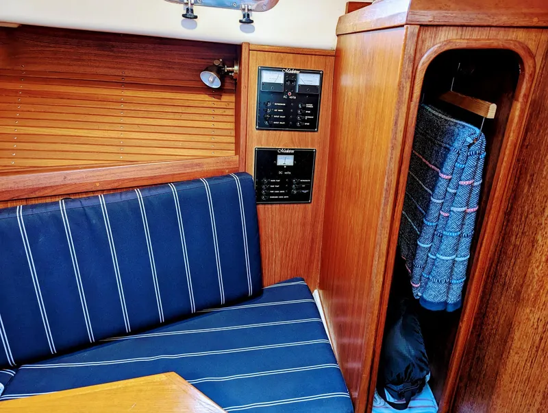 Slide: The Image of Interior of 2000 Hunt Yachts 29 with blue striped seating and wooden paneling. - 31