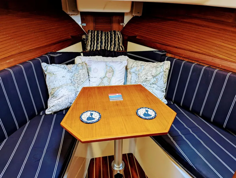 Slide: The Image of Cozy interior of 2000 Hunt Yachts 29 with striped cushions and nautical-themed pillows. - 32