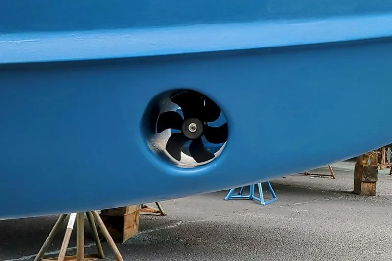 Slide: The Image of Close-up of a 2000 Hunt Yachts 29 bow thruster on a blue hull. - 36