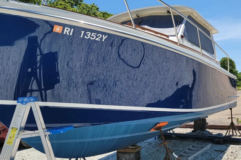 Slide: The Image of 2000 Hunt Yachts 29 boat on stands, blue hull, registration RI 1352Y. - 38