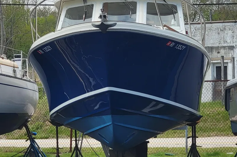 Slide: The Image of 2000 Hunt Yachts 29 boat with blue hull on stands, front view. - 39