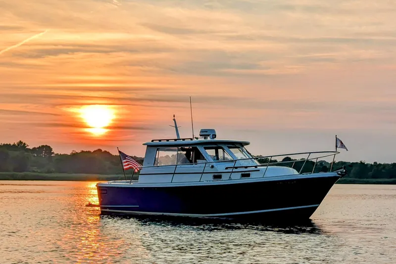 Slide: The Image of Hunt Yachts 28 Express 2000 cruising at sunset on calm waters. - 4