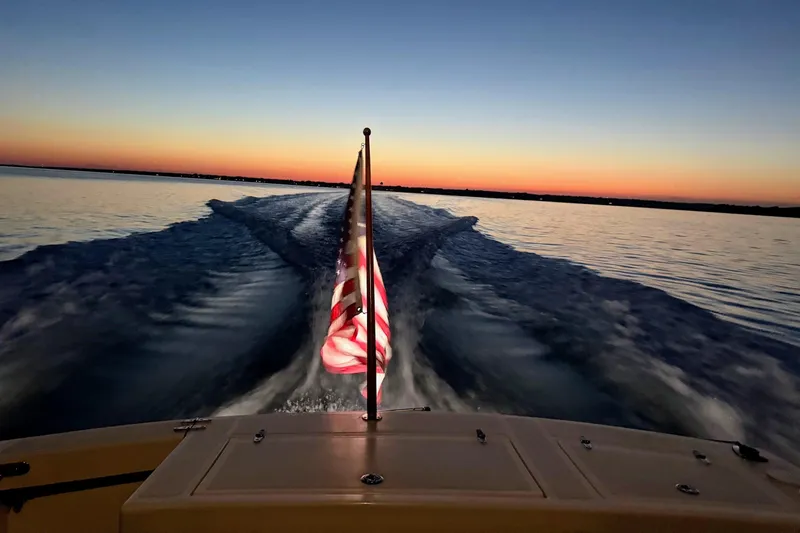 Slide: The Image of Sunset view from a 2000 Hunt Yachts 28 Express, American flag waving. - 42