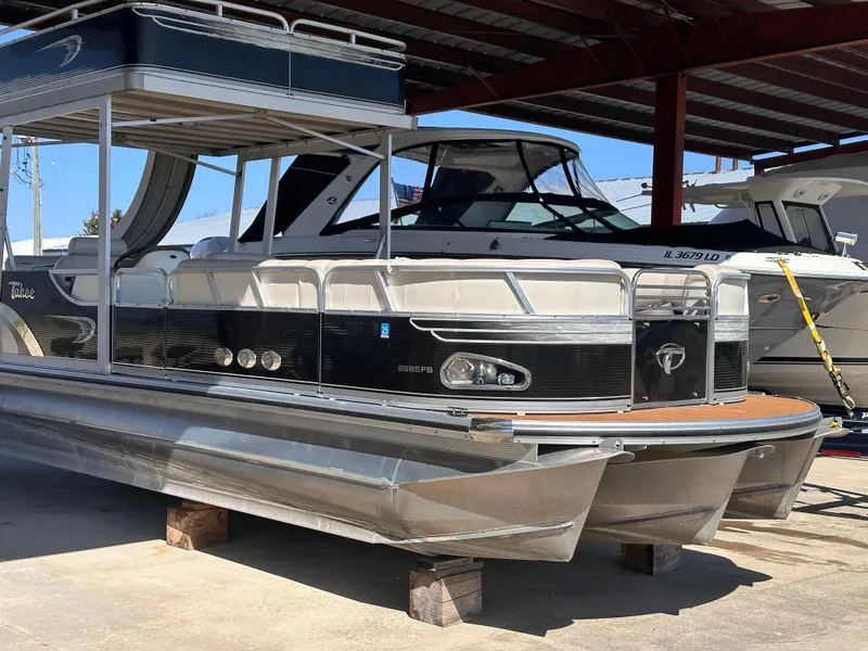 Slide: The Image of 2011 Tahoe Pontoon 2685FS Sierra Funship under a covered dock. - 3