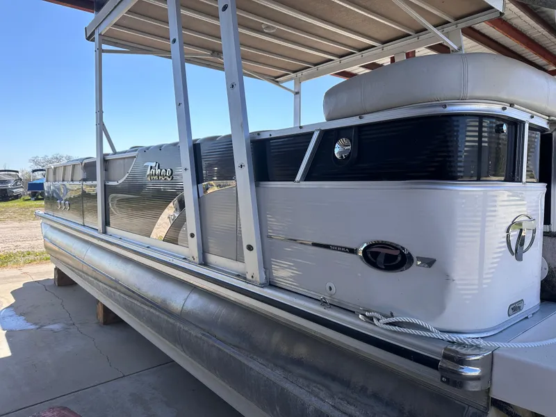 Slide: The Image of 2011 Tahoe Pontoon 2685FS Sierra Funship, docked under a canopy, side view. - 4