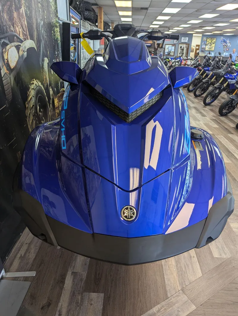 Slide: The Image of 2024 Yamaha Boats GP SVHO in showroom, sleek blue design, front view. - 11