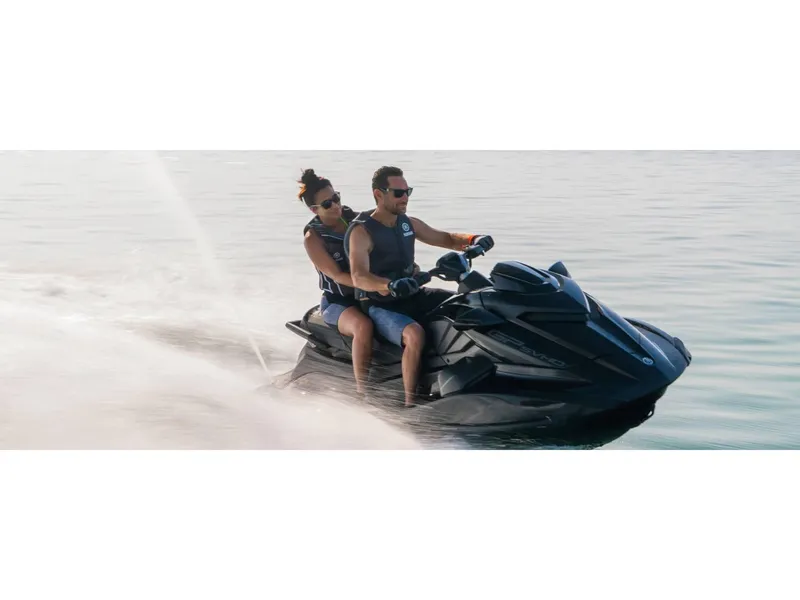 Slide: The Image of 2024 Yamaha Boats GP SVHO jet ski with two riders on calm water. - 21