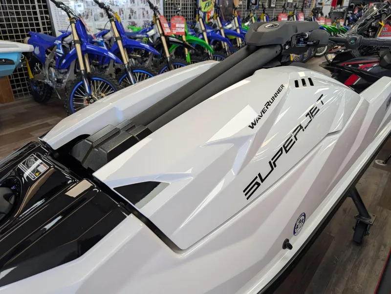 Slide: The Image of 2025 Yamaha Boats SUPERJET in showroom, surrounded by motorcycles. - 11