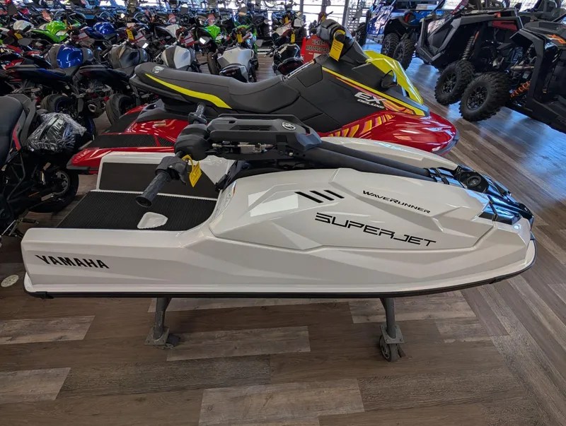 Slide: The Image of 2025 Yamaha Boats SUPERJET displayed in a showroom with other vehicles. - 13