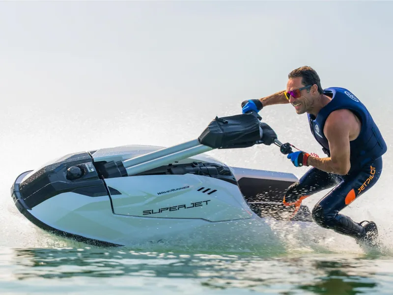 Slide: The Image of Man riding 2025 Yamaha SUPERJET on water, wearing a life vest and sunglasses. - 20