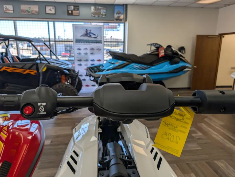 Slide: The Image of 2025 Yamaha Boats SUPERJET handlebar in showroom with other vehicles displayed. - 7