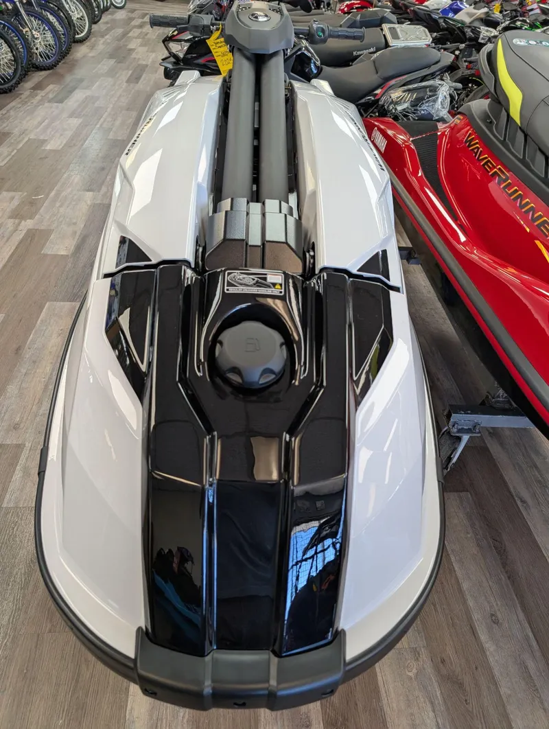 Slide: The Image of 2025 Yamaha Boats SUPERJET jet ski in showroom, sleek design, white and black color scheme. - 9