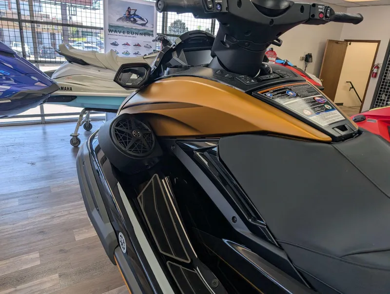 Slide: The Image of 2025 Yamaha FX Cruiser HO with Audio, gold and black, displayed indoors. - 5