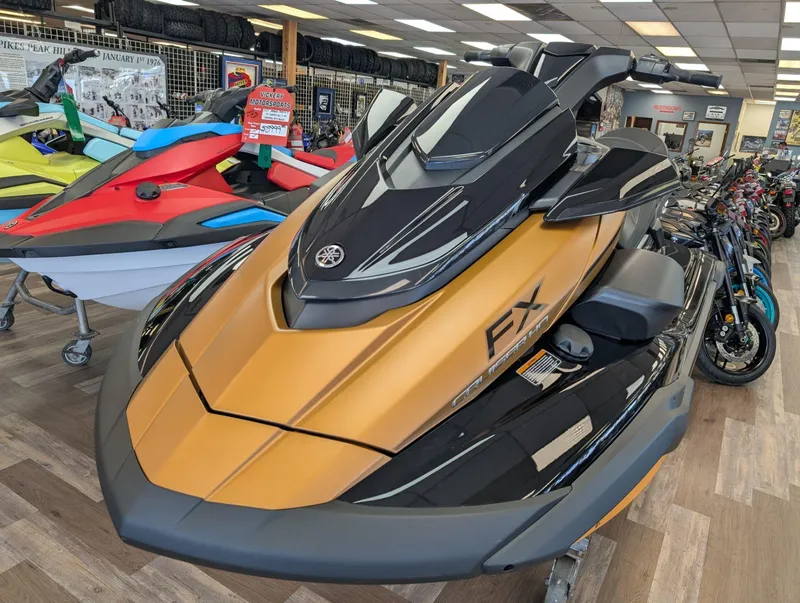 Slide: The Image of 2025 Yamaha FX Cruiser HO with Audio, gold and black, displayed in a showroom. - 7
