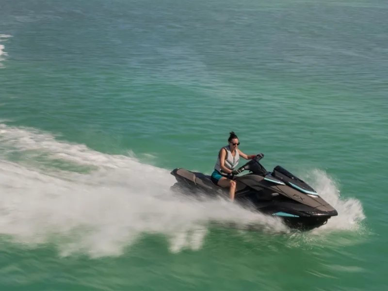 Slide: The Image of 2025 Yamaha FX HO with Audio jet ski speeding on turquoise water. - 11