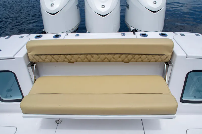 Slide: The Image of 2025 Sportsman Open 352 Center Console with beige cushioned seating and triple outboard motors. - 10