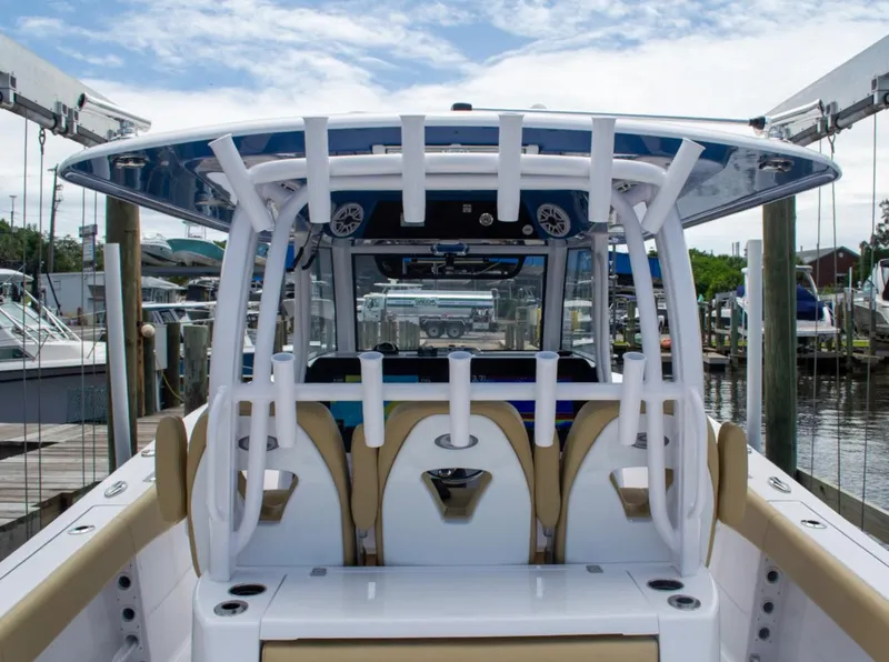 Slide: The Image of 2025 Sportsman Open 352 Center Console boat docked, featuring modern seating and sleek design. - 12