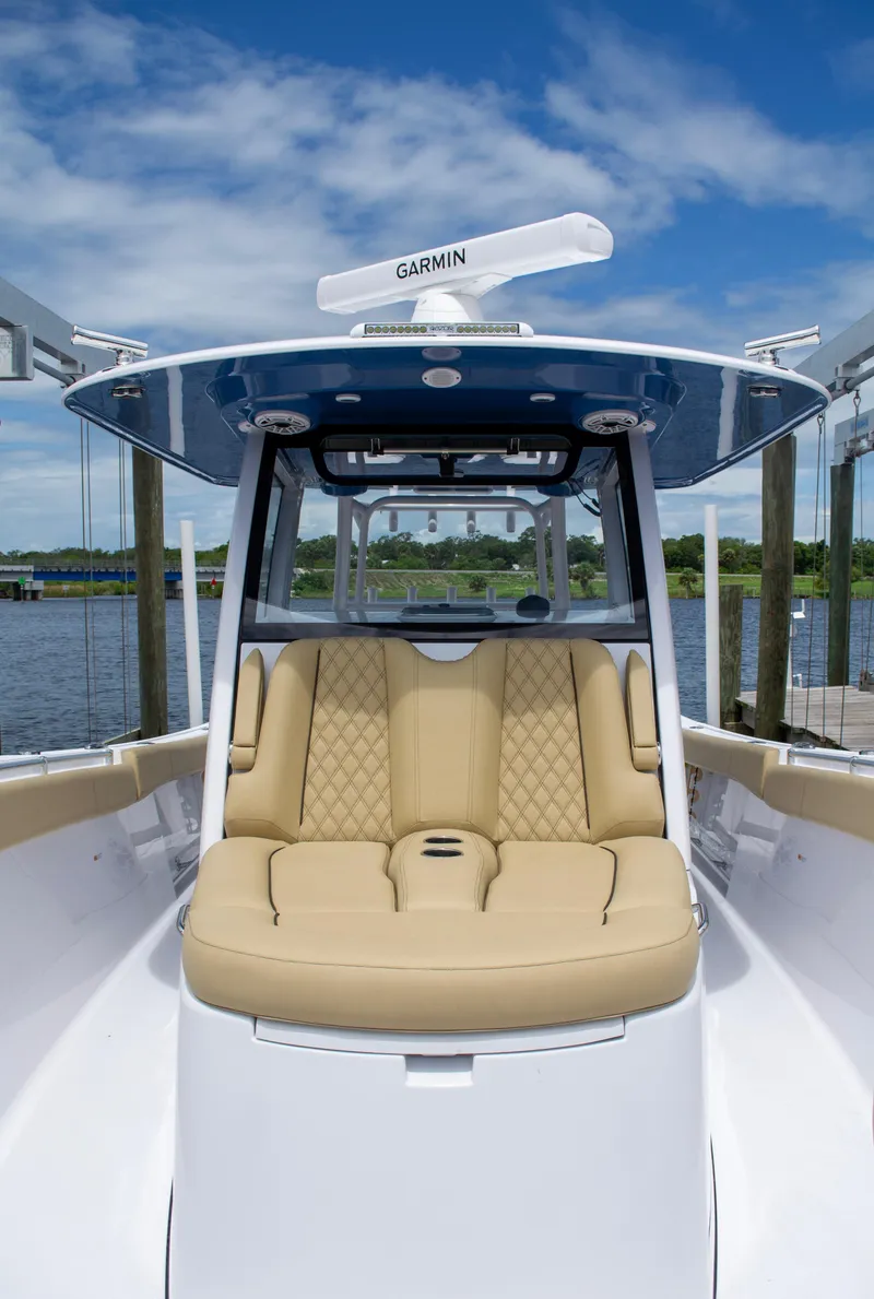 Slide: The Image of 2025 Sportsman Open 352 Center Console boat with tan seating and Garmin equipment. - 19