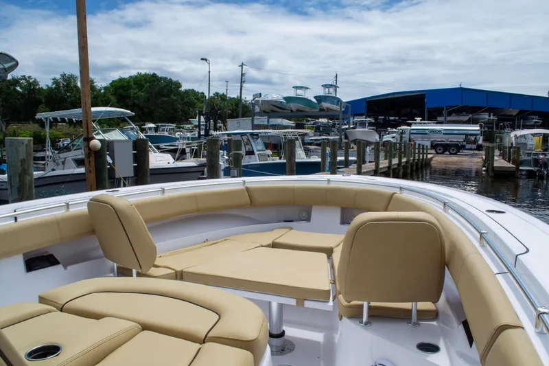Slide: The Image of 2025 Sportsman Open 352 Center Console boat docked at marina with beige seating. - 7