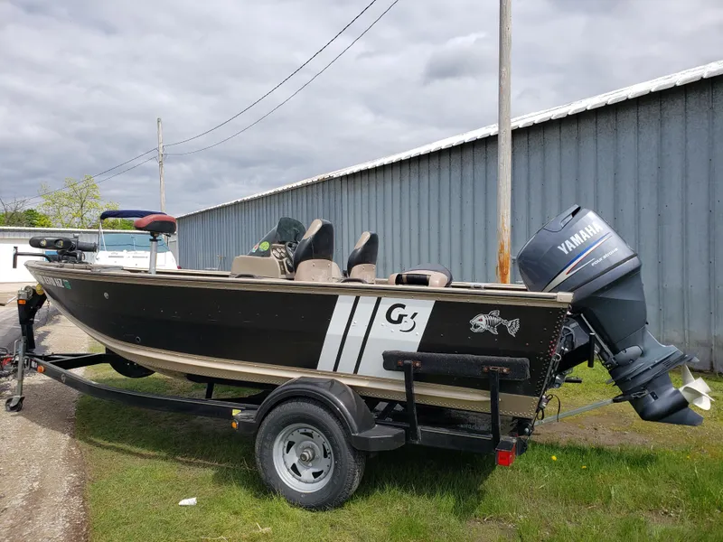 Slide: The Image of 2013 G3 V172C boat with Yamaha motor on trailer, parked outdoors. - 1