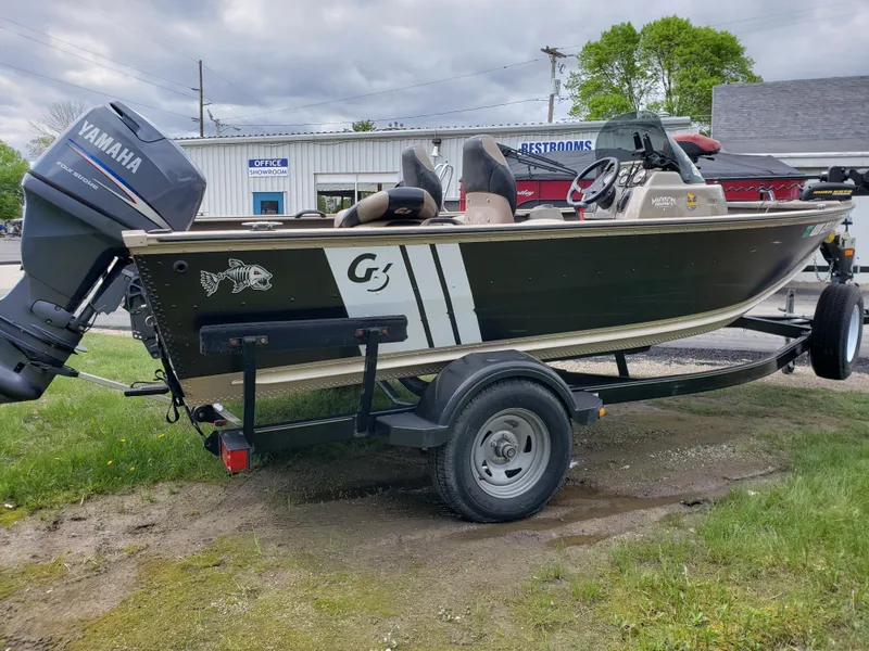 Slide: The Image of 2013 G3 V172C boat with Yamaha motor on trailer, parked outdoors. - 2