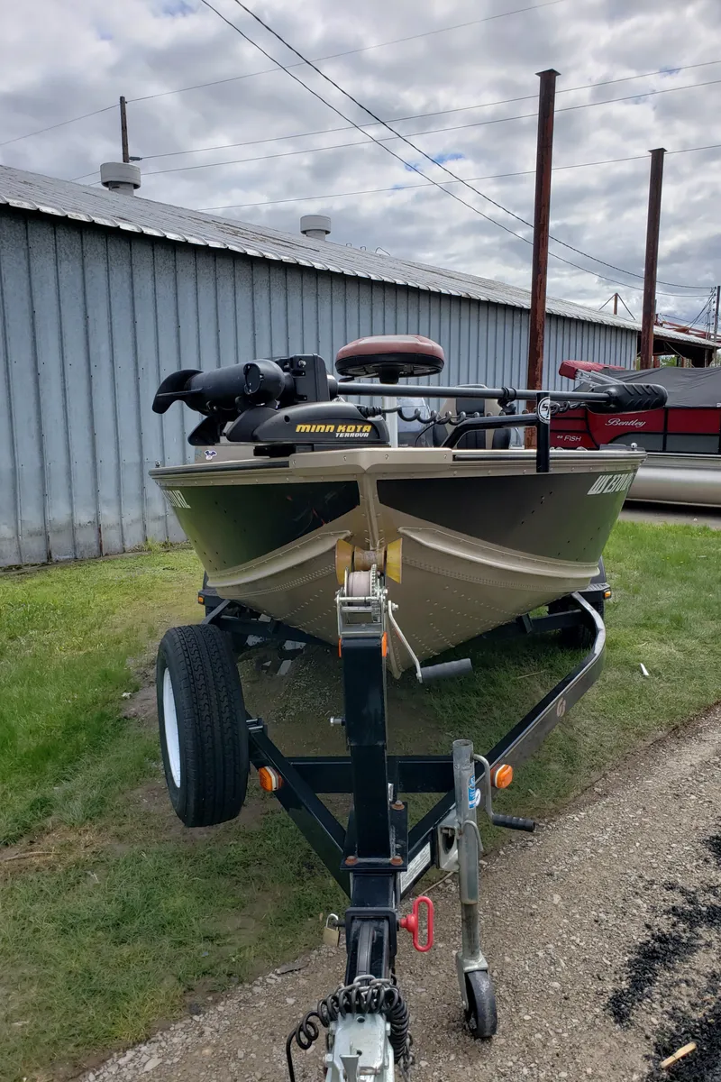 Slide: The Image of 2013 G3 V172C boat on trailer, parked beside a metal building under cloudy skies. - 4