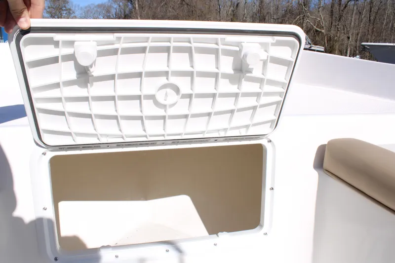 Slide: The Image of Open storage compartment on 2025 Sundance B20CCR boat, showcasing interior space. - 10
