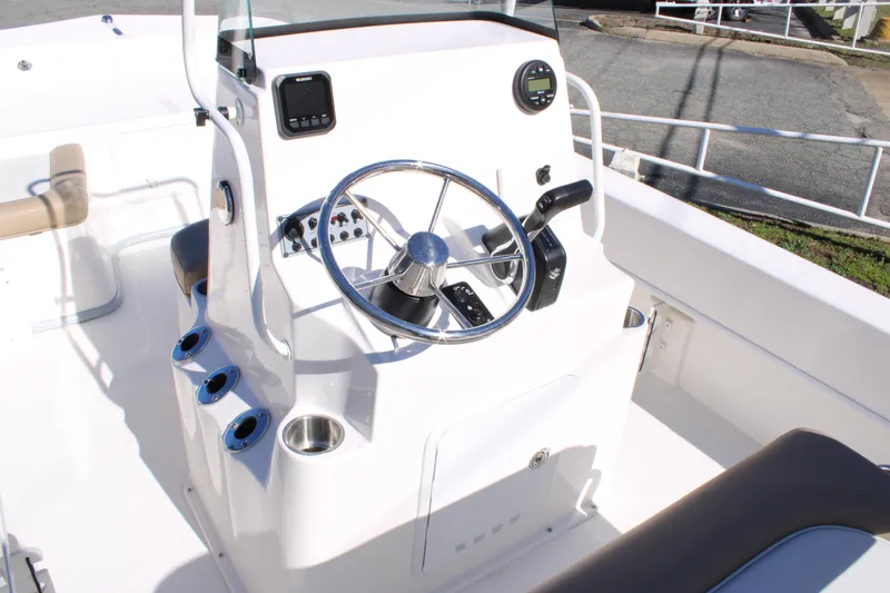 Slide: The Image of 2025 Sundance B20CCR boat console with steering wheel and controls. - 7