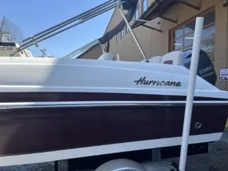 Slide: The Image of 2019 Hurricane CC19 boat on trailer, side view, with Yamaha engine. - 2