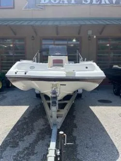 Slide: The Image of 2019 Hurricane CC19 boat on trailer outside service center. - 3