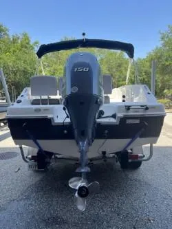 Slide: The Image of 2019 Hurricane CC19 boat with 150 HP engine, parked outdoors. - 5