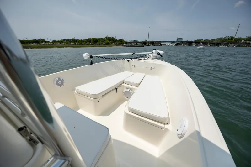 Slide: The Image of 2000 Pursuit 2470 Center Console boat on calm water, featuring spacious seating. - 10