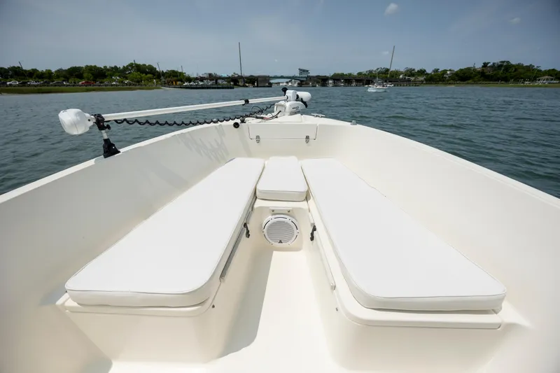 Slide: The Image of 2000 Pursuit 2470 Center Console boat with white seating on calm water. - 11