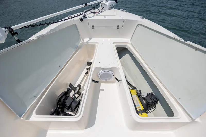 Slide: The Image of 2000 Pursuit 2470 Center Console boat with open storage compartments on deck. - 12