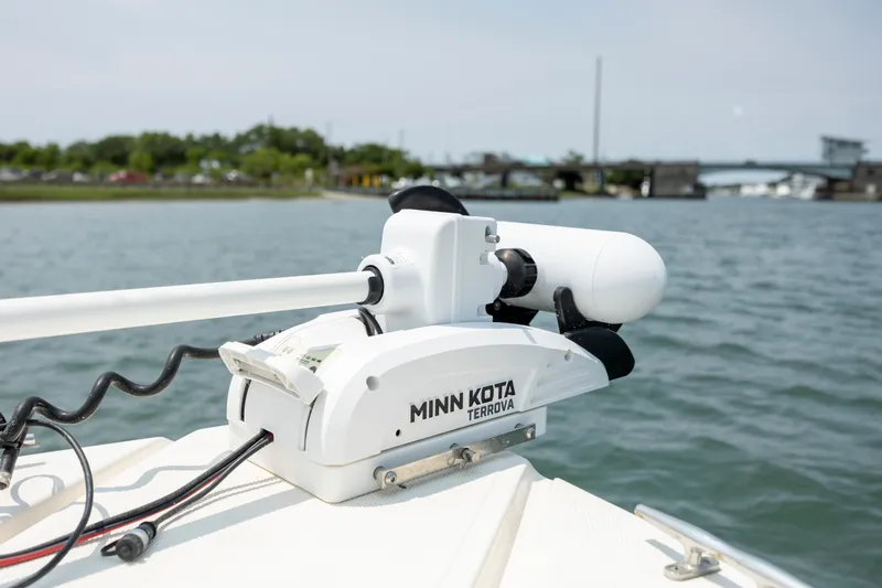 Slide: The Image of Minn Kota Terrova motor on 2000 Pursuit 2470 Center Console boat, near a bridge. - 13