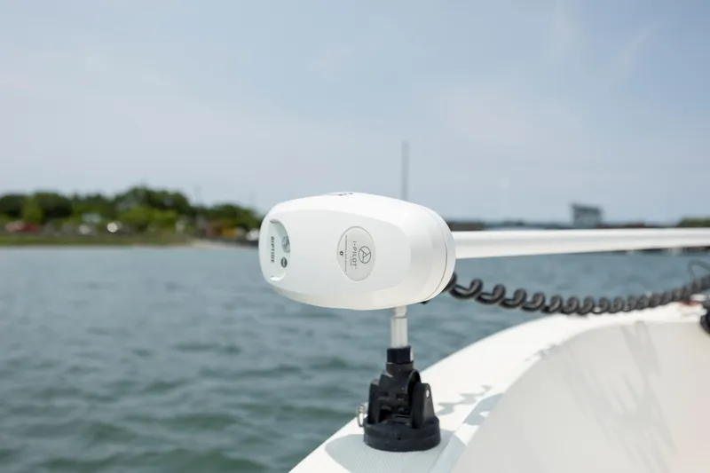 Slide: The Image of Close-up of a 2000 Pursuit 2470 Center Console boat's anchor system on water. - 14