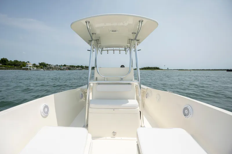 Slide: The Image of 2000 Pursuit 2470 Center Console boat on calm water, clear sky background. - 15