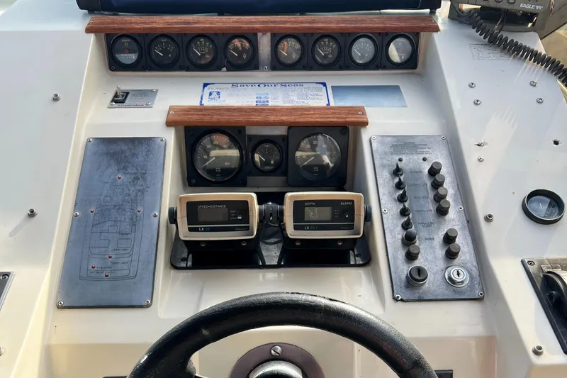 Slide: The Image of 1988 Silverton 34X Express dashboard with gauges, controls, and steering wheel. - 11