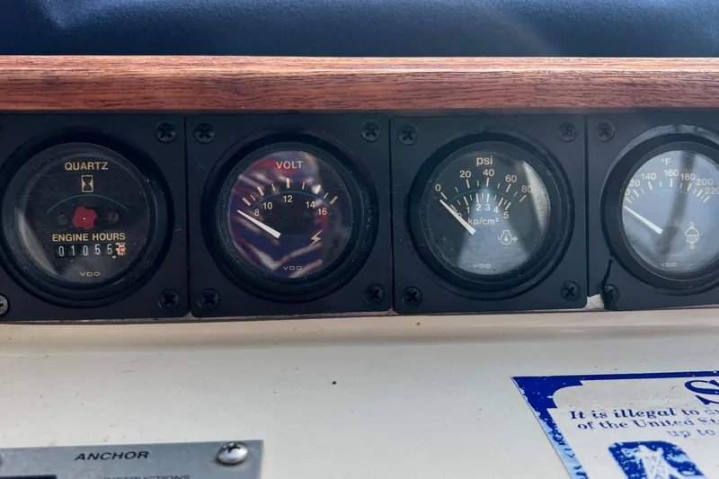 Slide: The Image of Dashboard gauges of a 1988 Silverton 34X Express boat, showing engine hours and voltage. - 12