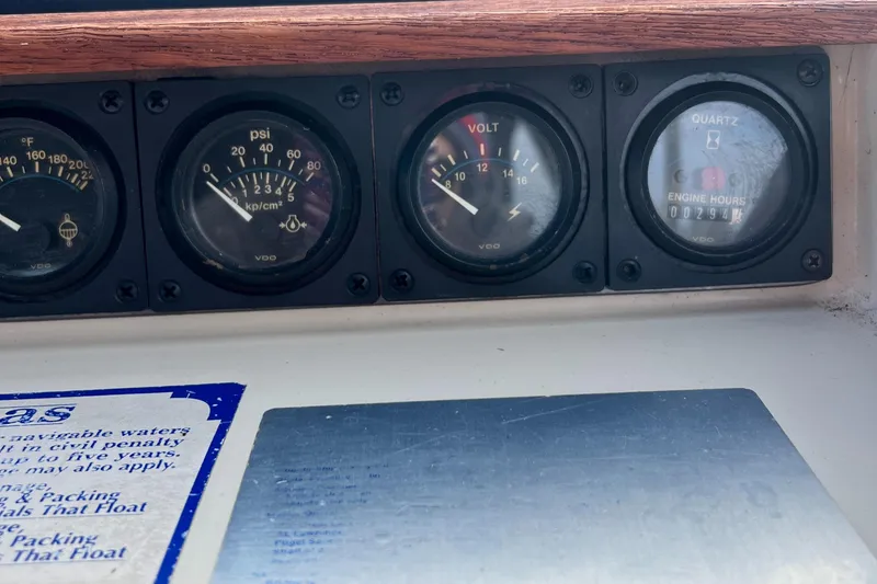 Slide: The Image of Dashboard gauges of a 1988 Silverton 34X Express boat, showing pressure, voltage, and engine hours. - 13