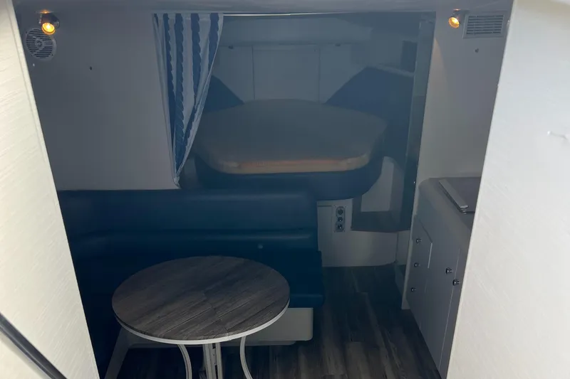 Slide: The Image of 1988 Silverton 34X Express cabin interior with seating, table, and bed. - 14