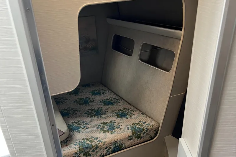 Slide: The Image of 1988 Silverton 34X Express cabin interior with floral-patterned bedding. - 15