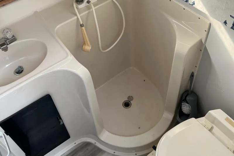 Slide: The Image of 1988 Silverton 34X Express boat bathroom with shower, sink, and toilet. - 21