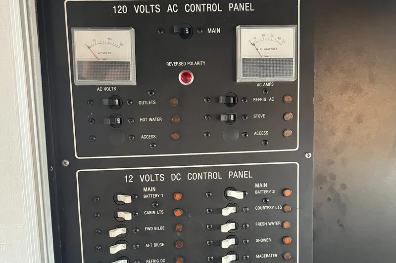 Slide: The Image of 1988 Silverton 34X Express control panel with 120V AC and 12V DC switches. - 22