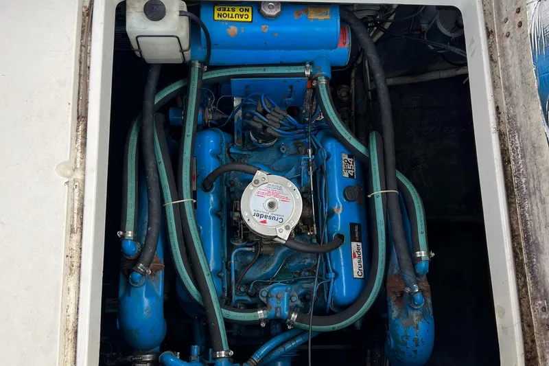 Slide: The Image of 1988 Silverton 34X Express engine compartment with blue engine and hoses. - 24