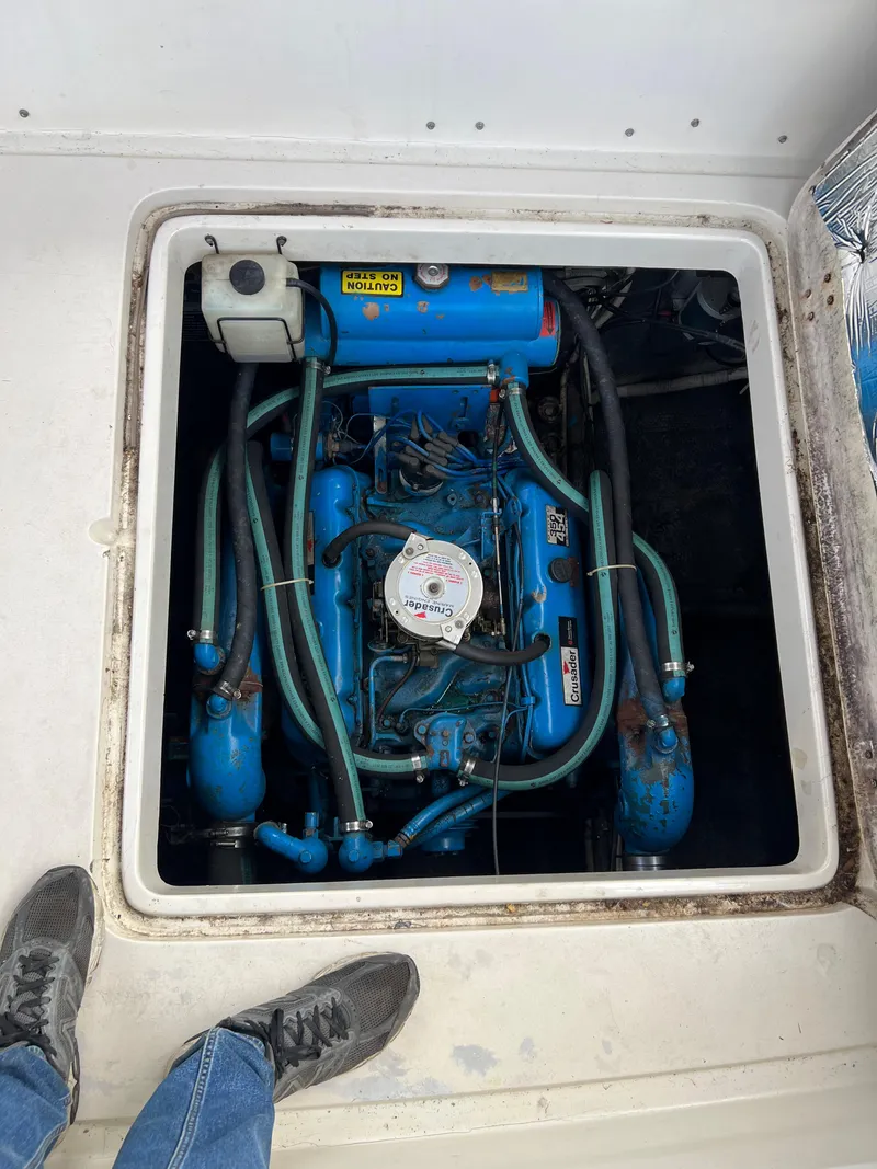 Slide: The Image of Engine compartment of a 1988 Silverton 34X Express boat, featuring a blue engine. - 5